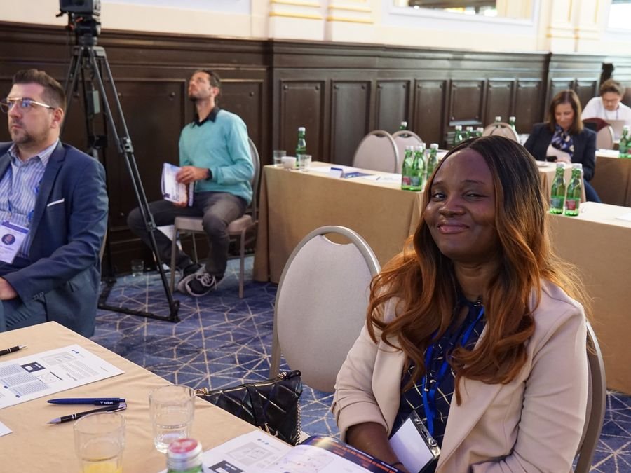 A delegate smiling during a session at Hotel KINGS COURT, Prague, 2026 edition of the Global Future of BPO, Shared Services & GBS Conference