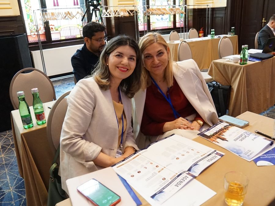 Two delegates with the conference agenda at Hotel KINGS COURT, Prague, 2026 edition of the Global Future of BPO, Shared Services & GBS Conference