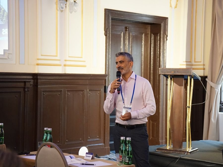 A speaker addressing the room by the lectern at Hotel KINGS COURT, Prague, 2026 edition of the Global Future of BPO, Shared Services & GBS Conference