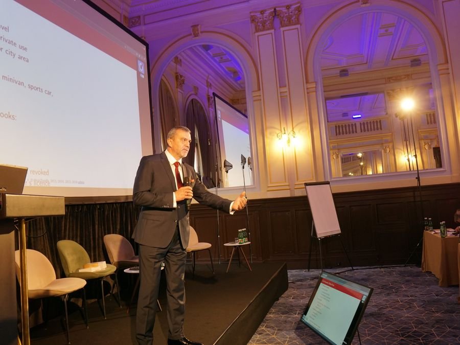 A speaker presenting on stage under the chandeliers at Hotel KINGS COURT, Prague, 2026 edition of the Global Future of BPO, Shared Services & GBS Conference